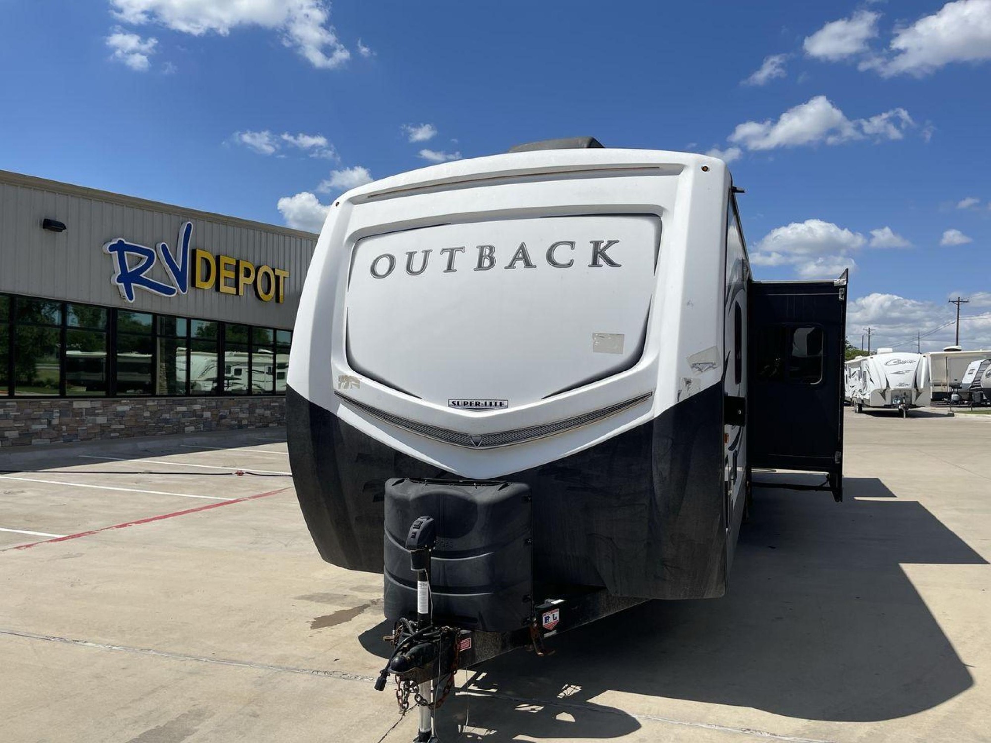 2018 BLACK KEYSTONE RV OUTBACK 325BH (4YDT32520JB) , Length: 37.42 ft. | Dry Weight: 8,428 lbs. | Gross Weight: 10,500 lbs. | Slides: 3 transmission, located at 4319 N Main St, Cleburne, TX, 76033, (817) 678-5133, 32.385960, -97.391212 - Gather the family inside this Outback Super Lite 325BH by Keystone RV, which features a bunkhouse, front bedroom, outside kitchen, and triple slides. The dimensions of this 325BH model are 37.42 ft in length, 8 ft in width, and 11.33 ft in height. It has a dry weight of 8,428 lbs with a payload capa - Photo #0
